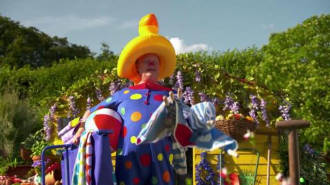 Mr Tumble plays some games outside in his garden.