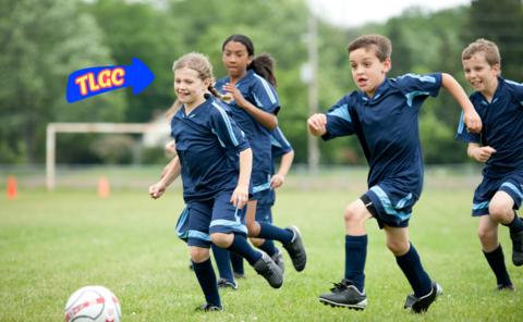 children run to catch a football