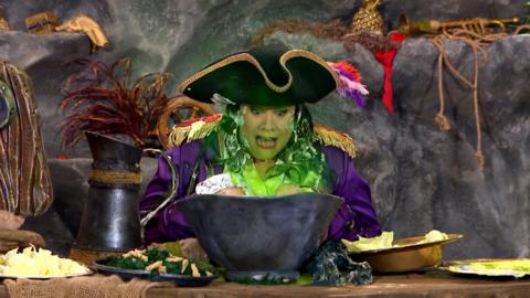 Captain Captain has her hands stuck in the bowl