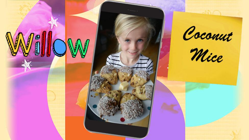 A girl shows a plate of Coconut Mice biscuits that she has made.