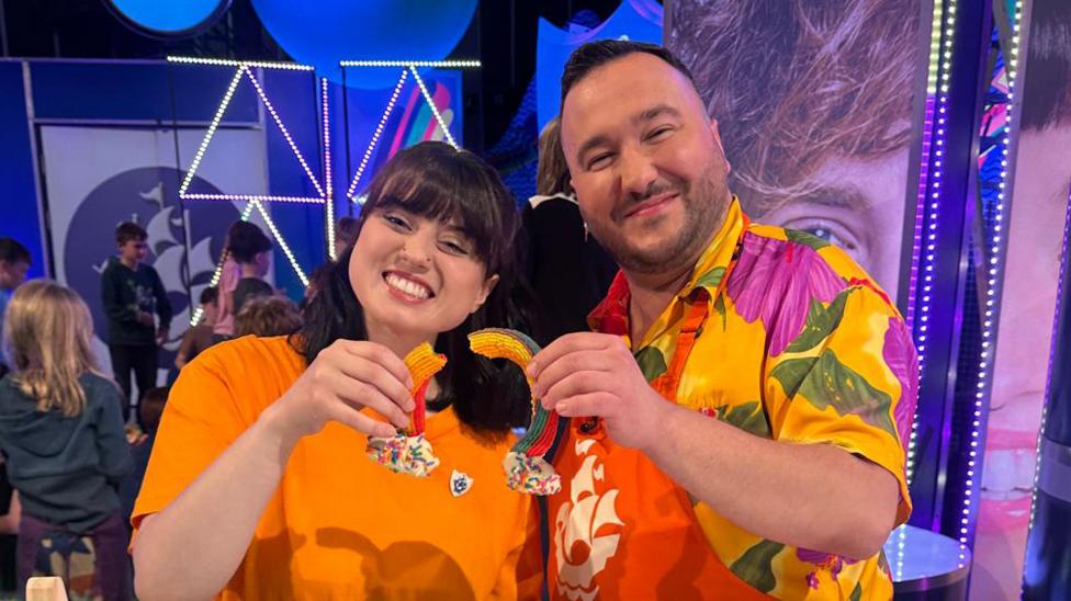 Abby and Janusz with the Rainbow biscuit bake