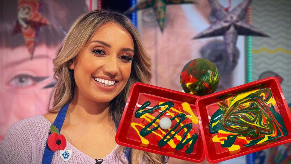 Nikita Kanda smiles in front of a tray of multicoloured paints and a ping pong ball, it is showing step by step instructions on how to roll your pingpong ball through the paint.