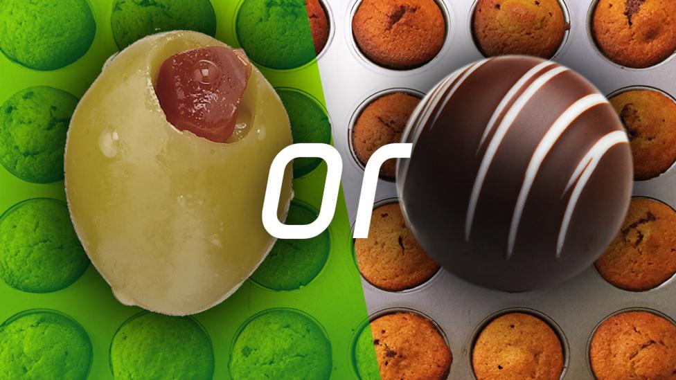 An olive, the word "or" and a chocolate truffle, with cupcakes in the background