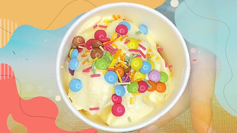 ѿýmade ice cream with lot of sprinkles.