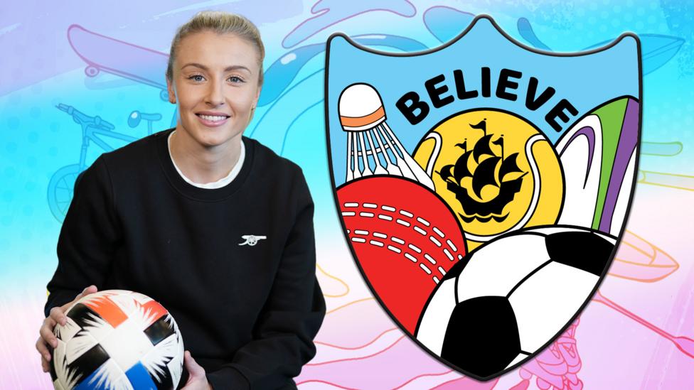 Footballer Leah Williamson is blonde and wearing a black sweatshirt, she is holding a football, there is a large Blue Peter sport badge to her right featuring various balls from different sports.