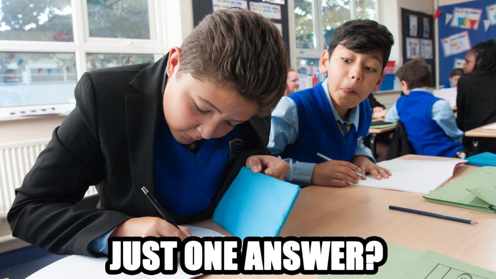 A boy copying another boy at school with: 'Just one answer?'.