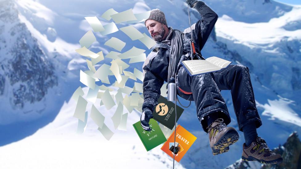 A man abseiling with books in snow.