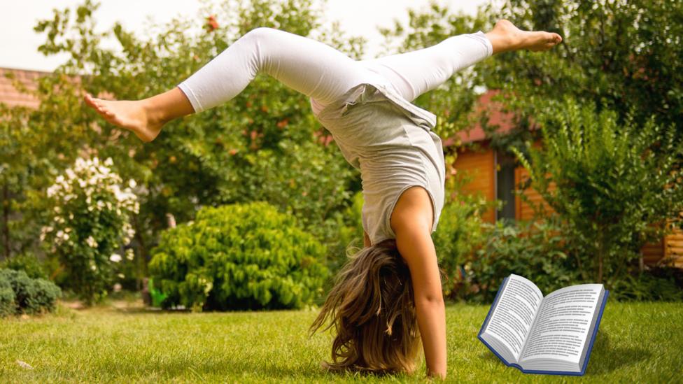 A girl doing a handstand while reading.