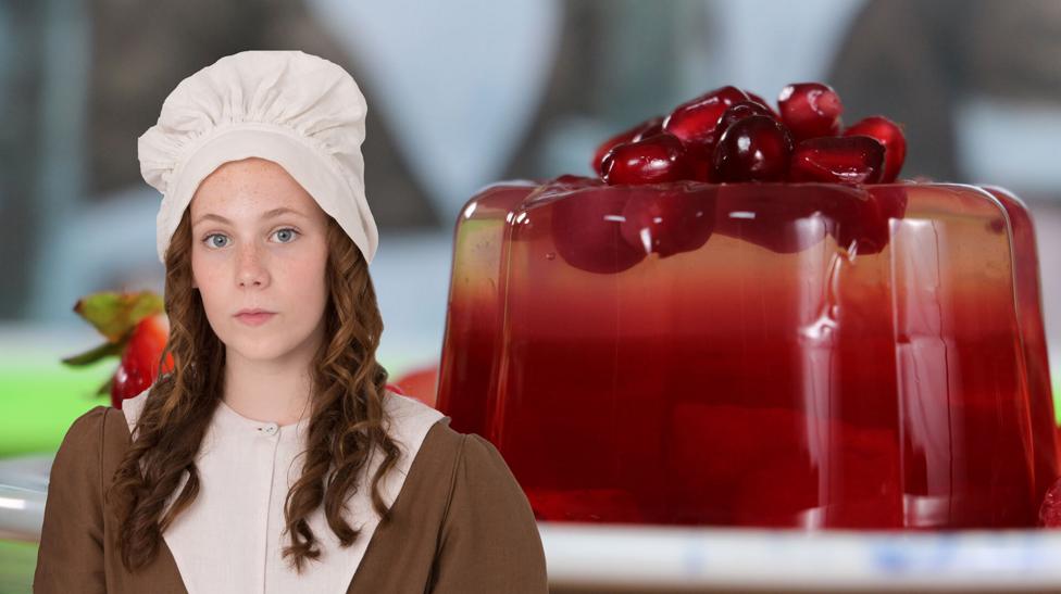 A young girl in victorian clothing in front of a plate of berry jelly.