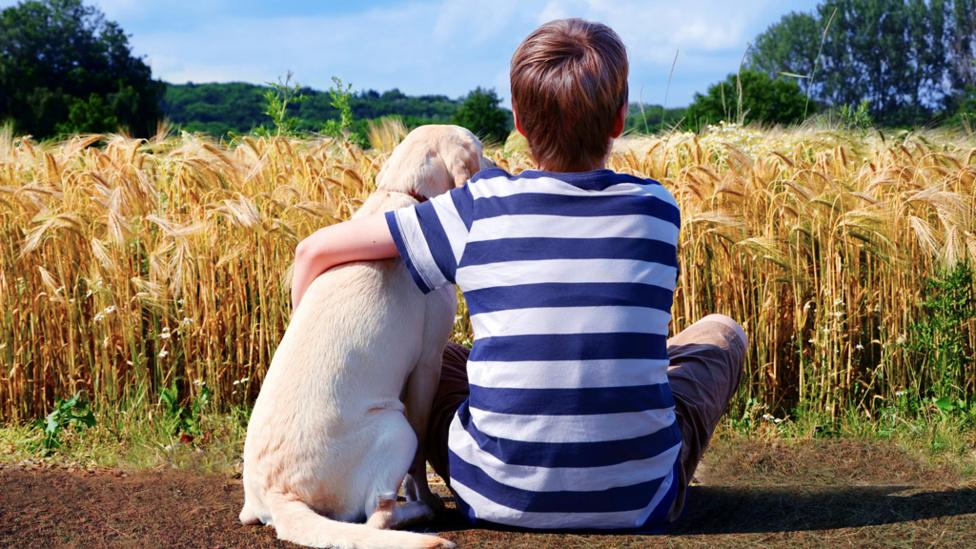 man hugging a dog