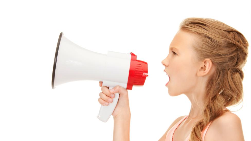 A girl shouting through a megaphone