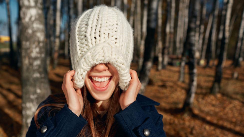 Girl pulling down woolly hat