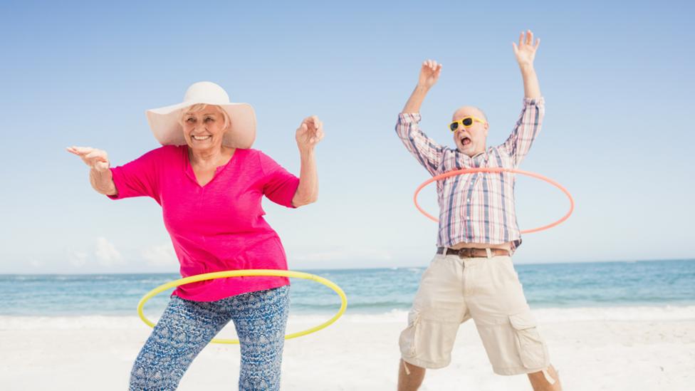 Old couple hula hooping