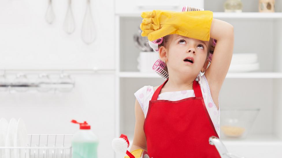 Child tired from washing dishes