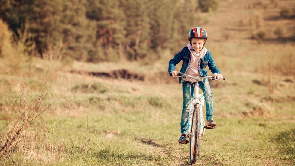 Boy riding bike outside