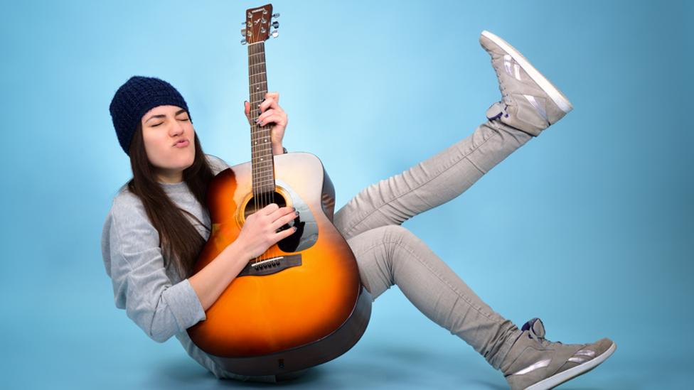 Teen girl playing guitar