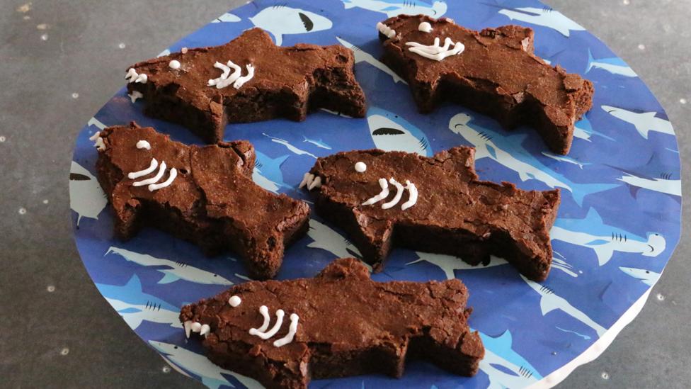 A plate of brownies made to look like sharks.