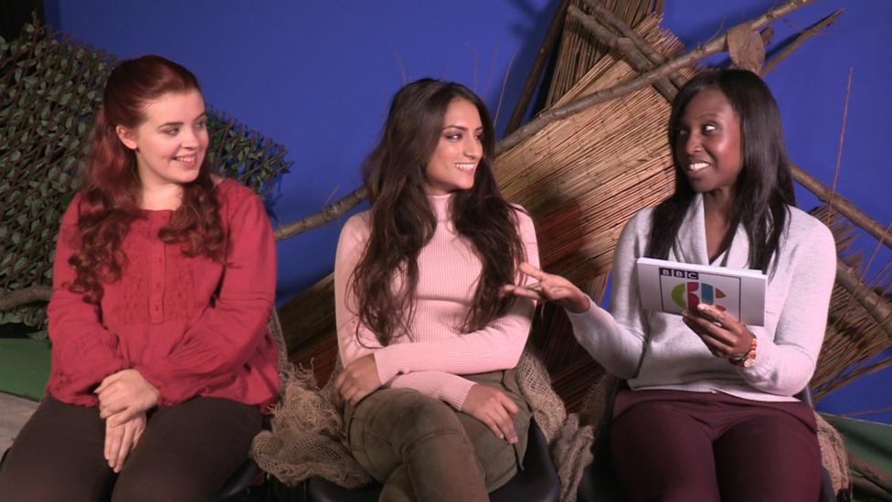 The Wolfblood girls against a blue screen with props behind.