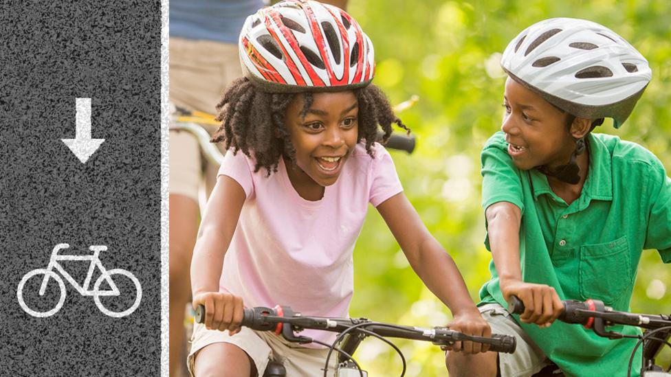 Two children riding biked and they both looks very happy