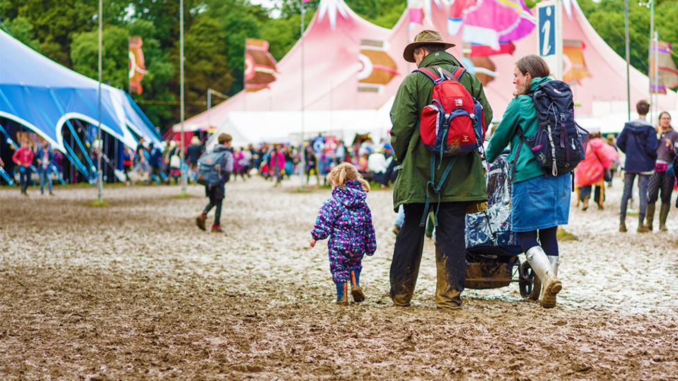 Parents with two small children at music festival