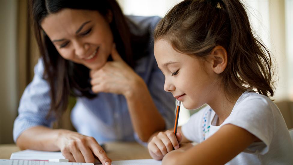 Mother and daughter doing homework together.