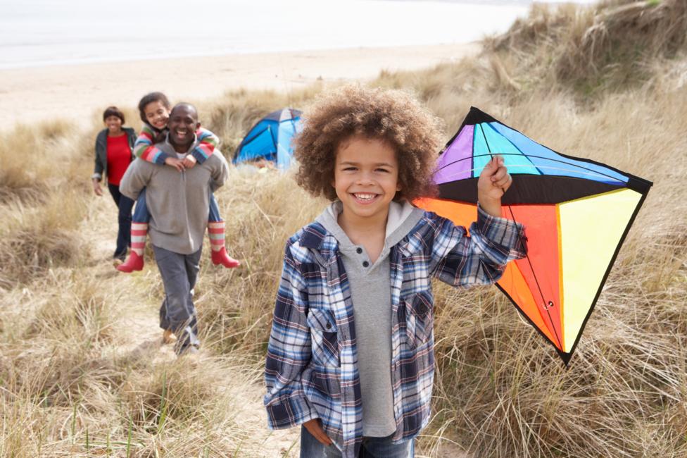 Children and their parents flying kites.