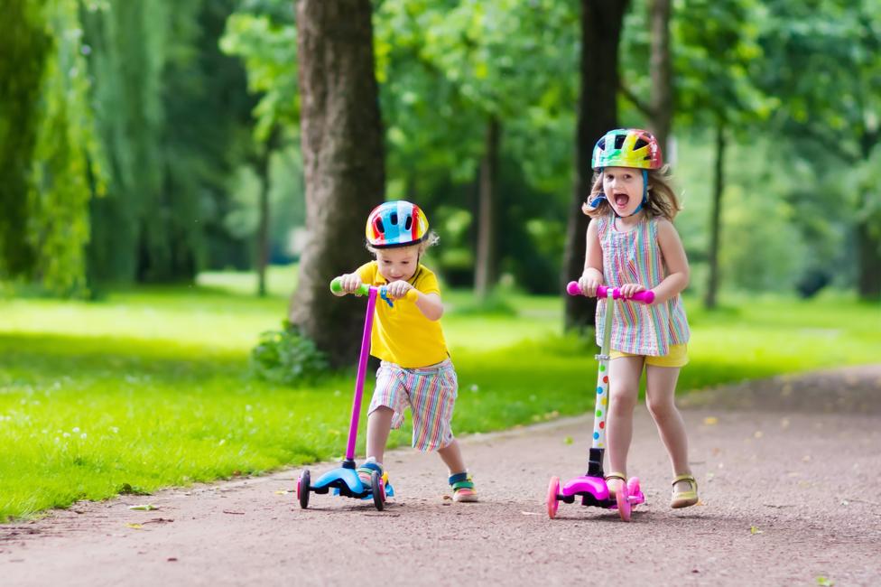 kids riding scooters outdoors.