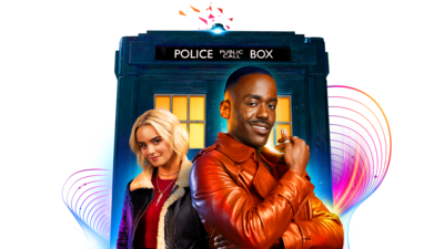 The Doctor and Ruby Sunday posed infront of the TARDIS blue police box, the Doctor is a black man and holding his sonic screwdriver and smiling warmly. Ruby is a white woman, young with blonde hair, she is also smiling. They are both wearing fashionable jackets.