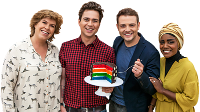 Four people stand in a group holding a chocolate cake with bright colourful layers inside it (Bake Off Judges and Sam and Mark).