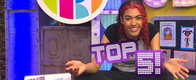 Alishea sat on the CBBC HQ table with 'Top 5'.
