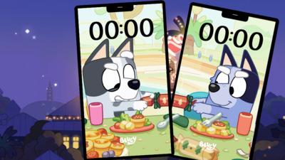 Two phones showing images of two characters from Bluey pulling a christmas cracker.