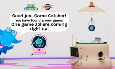 Mr Moustache is peeking from the side of the image with speech text that reads 'good job game catcher! You have found a new game. One game-sphere coming right up!'.There is a sphere below with a cut out line around it. The game machine is in the background picking up the same sphere.