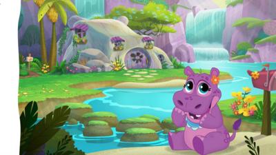 Illustration showing a purple baby hippo wearing a blue bib and an orange flower in their hair. Two baby teeth are coming through. They are looking cutely at the camera. In the background there is her stone home next to a waterfall.