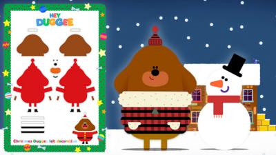 Hey Duggee is stood outside in his winter outfit building a snow man with a Christmas instruction to create your very own Duggee felt decoration.