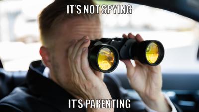 Man with binoculars in car.