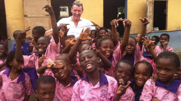 presenter Jim O’Neill with school children in the Nigerian capital, Lagos
