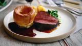 Treacle-cured beef with Yorkshire puddings and roast potatoes