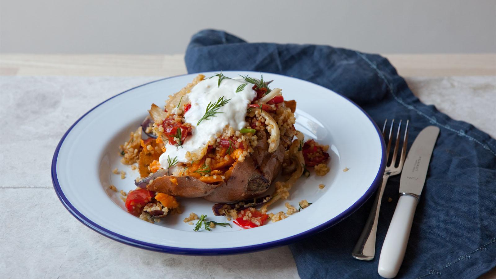 Baked sweet potato with roasted vegetables and bulgur wheat