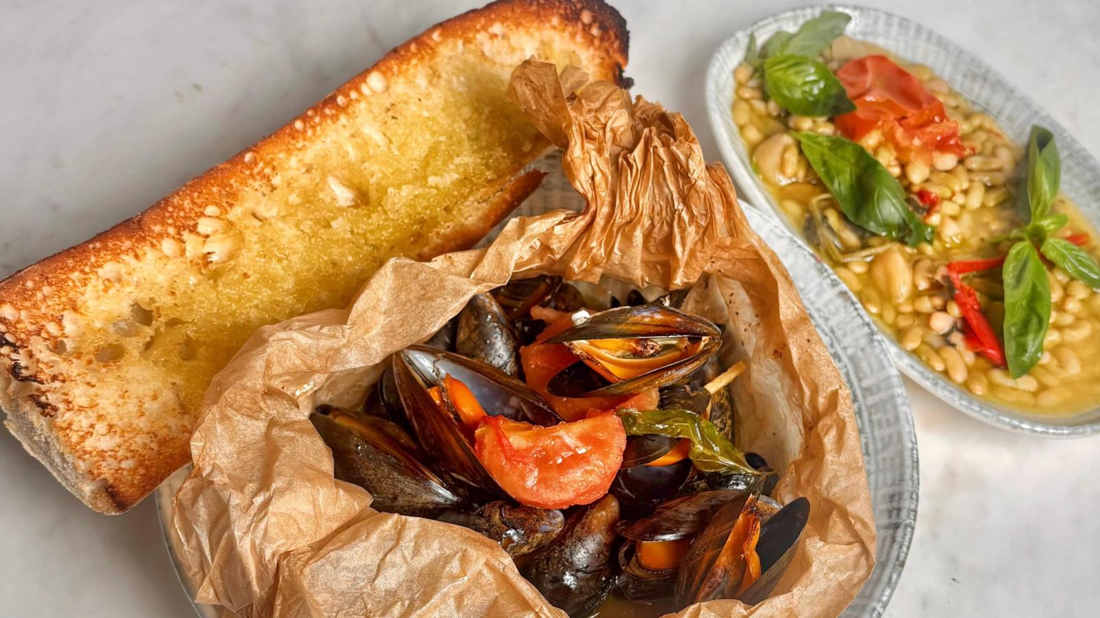 Mussels en papillote with garlic baguette and flageolet beans