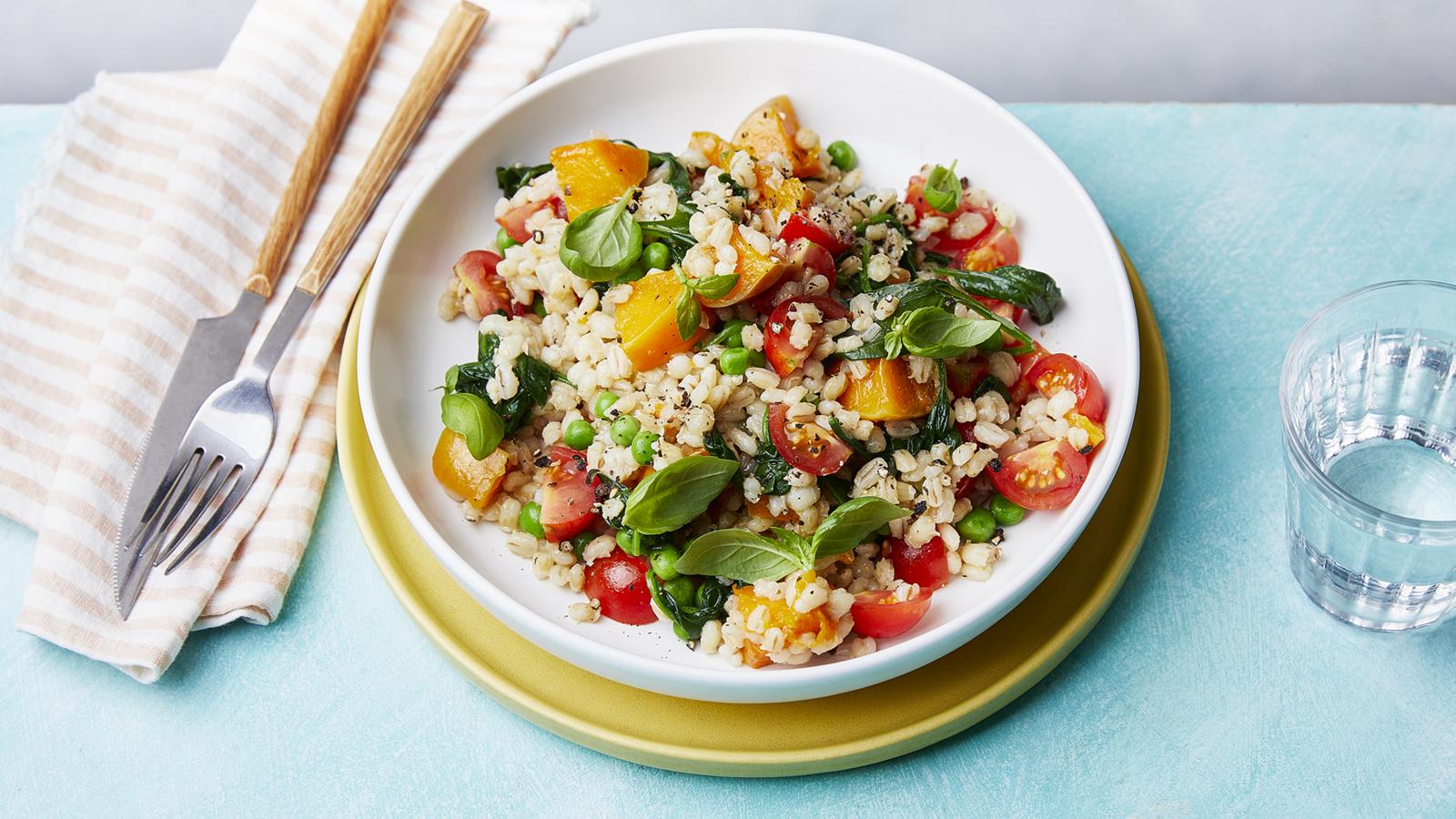 Pearl barley with spinach, peas, tomatoes and butternut squash