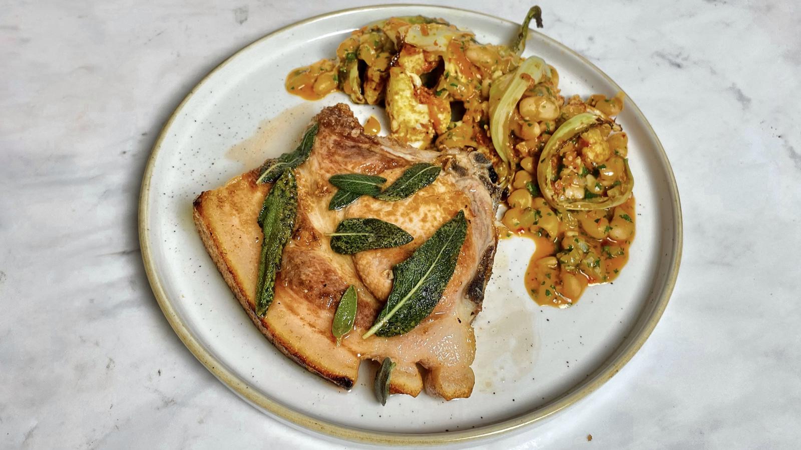 Pork chop with roasted cauliflower and ’nduja white beans 