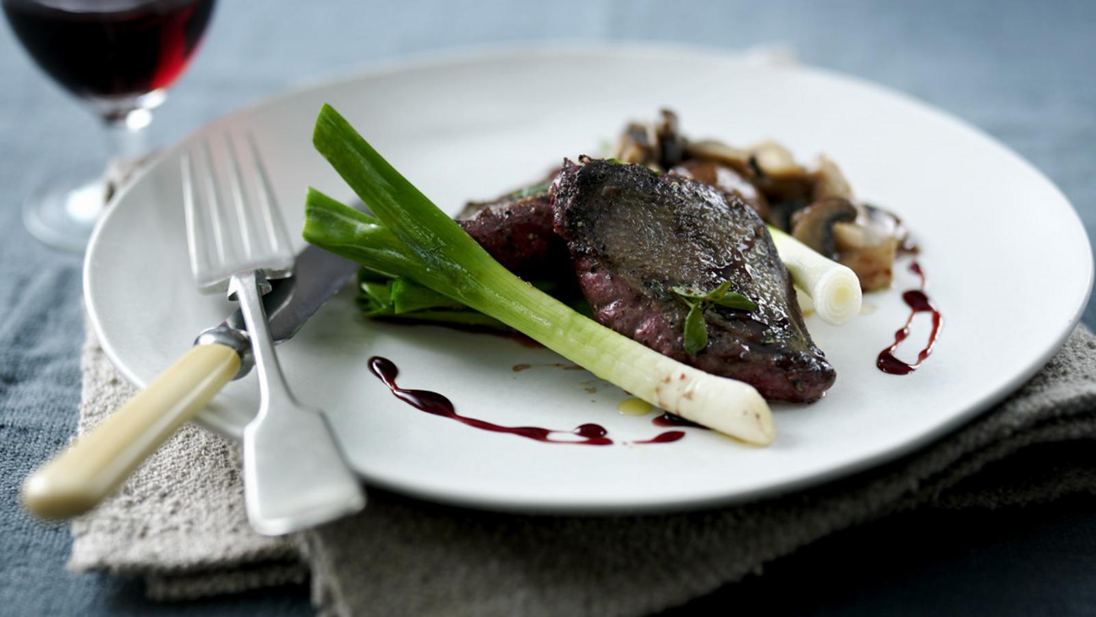 Pigeon breast with red wine gravy, roast leeks and wild mushrooms