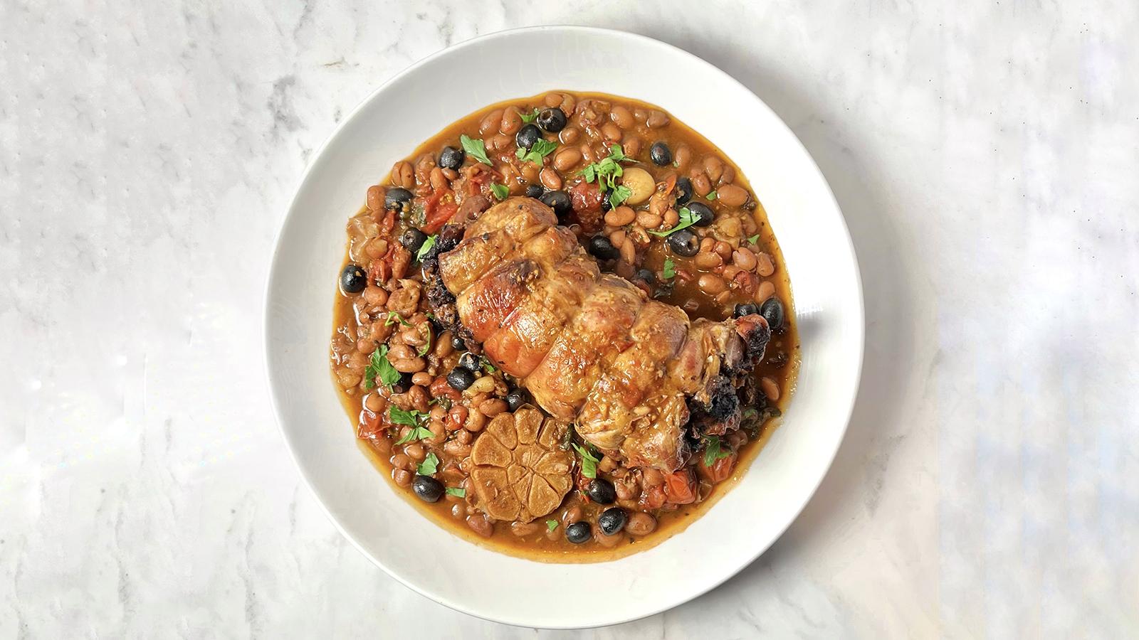 Rolled lamb shoulder with olives and borlotti beans