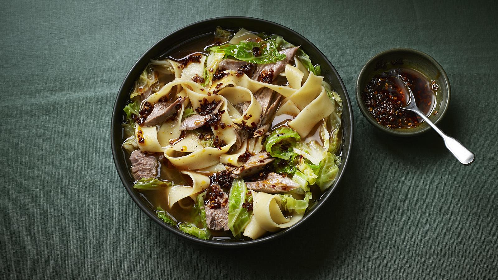 Wide noodles with lamb shank in aromatic broth