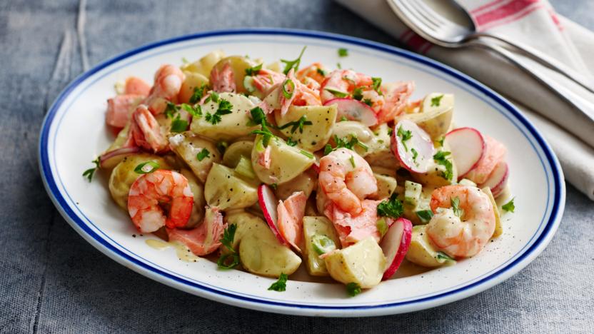 Creamy potato salad with salmon and prawns