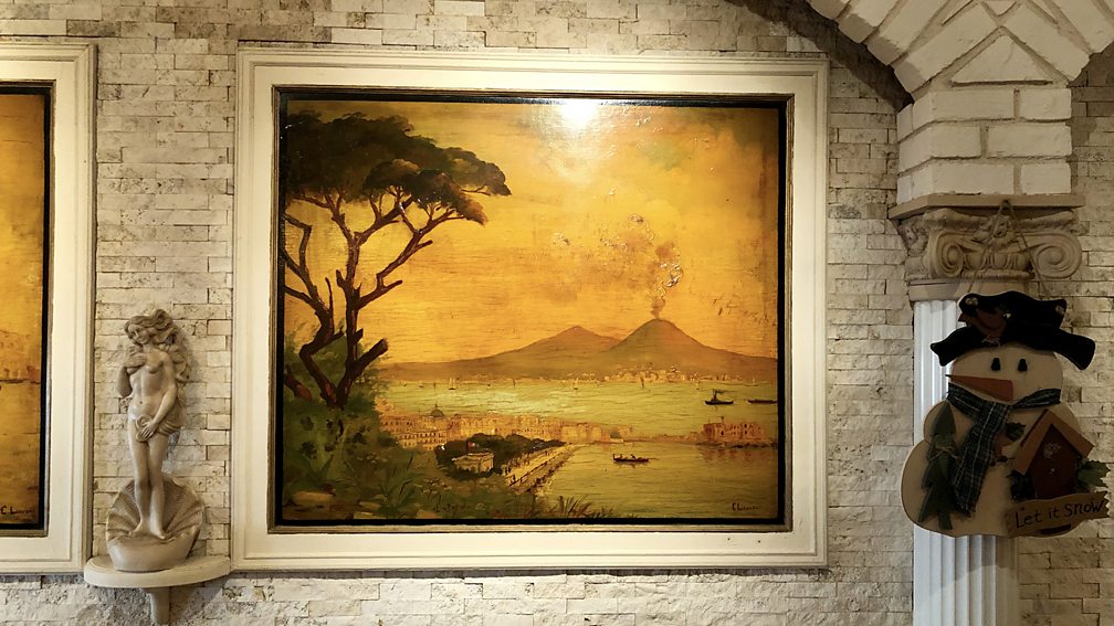 Danielle Oteri Mario's dining room is filled with old images of Naples painted by a distant Italian relative (Credit: Danielle Oteri)
