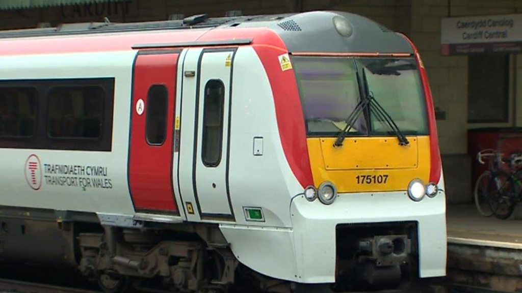 A train being painted with the Transport for Wales livery