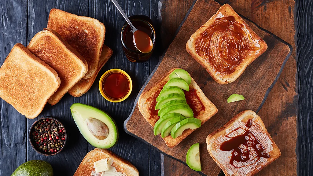 A full English breakfast on a plate with toast and a cup of coffee (Credit: Getty Images)