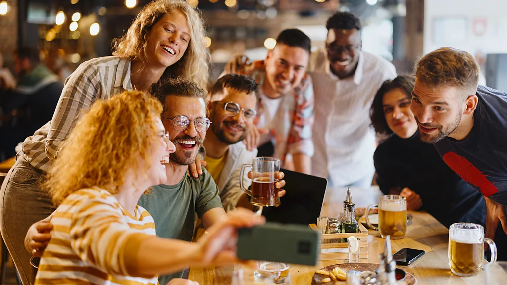 Qualities that relate to familiarity, such as approving of a partner's friends, might help us become attracted to someone broadly similar to us (Credit: Getty Images)