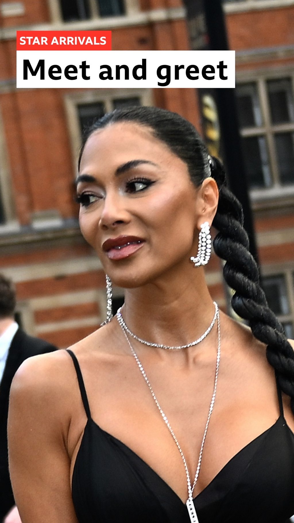 Nicole Sherzinger in a black dress with a silver necklace